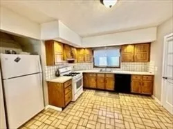 a kitchen with a cabinets and white appliances