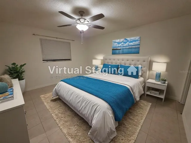 a bedroom with bed and a chandelier