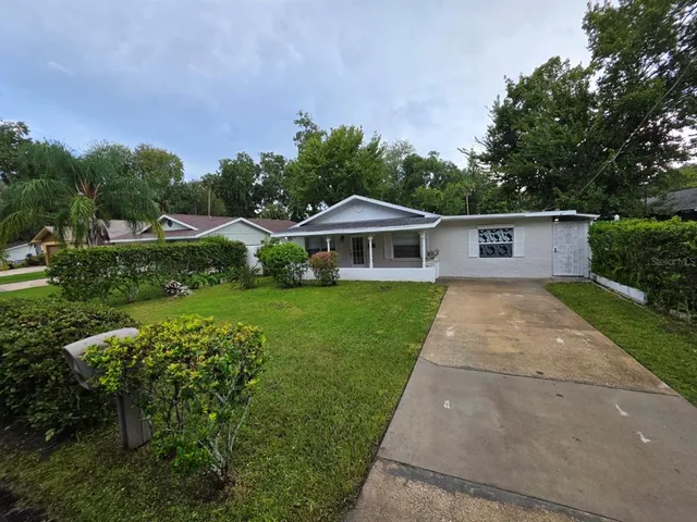 a front view of house with yard and green space