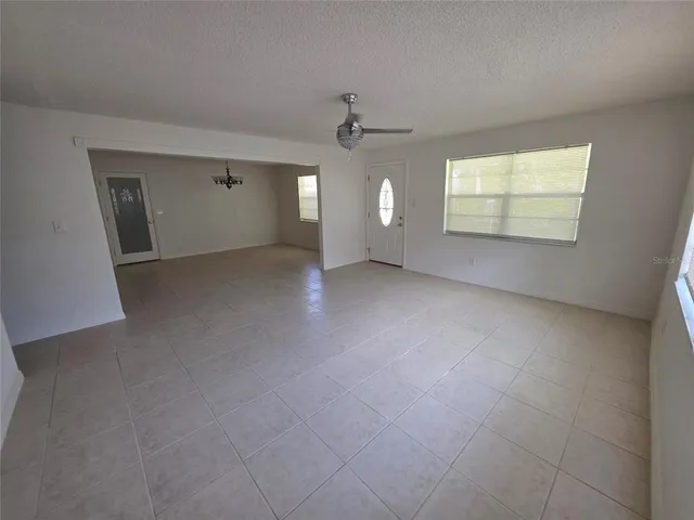 an empty room with windows and cabinet