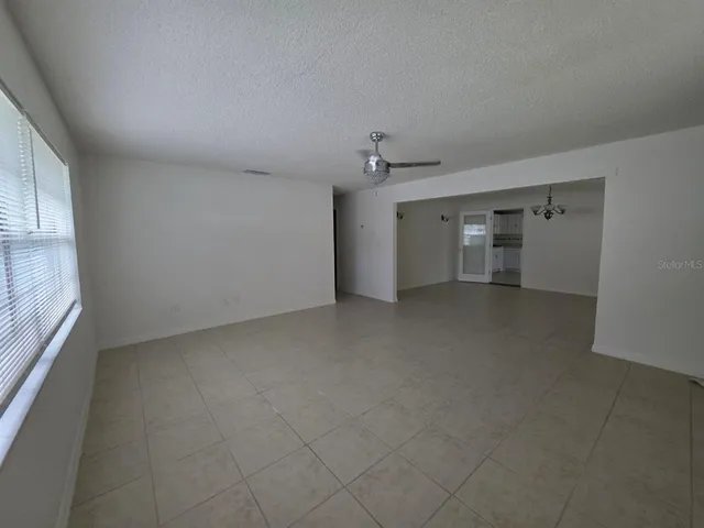 an empty room with a empty space and windows