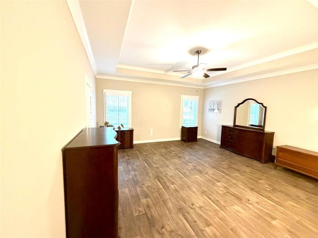 386 Westminster Trail Winder, GA 30680 - Photo 12 of 20 a bedroom with a bed and dresser with mirror