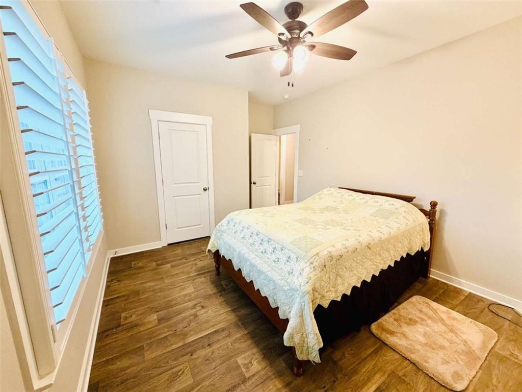 386 Westminster Trail Winder, GA 30680 - Photo 18 of 20 a bedroom with a bed lamps and a chandelier