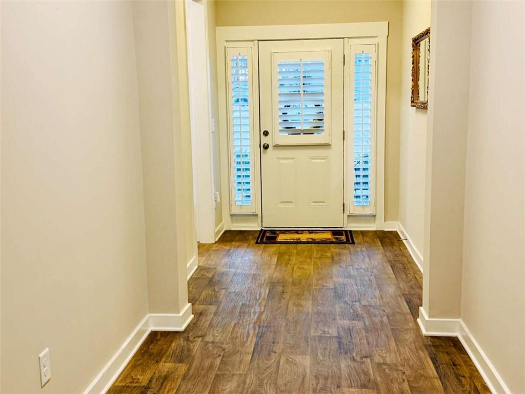386 Westminster Trail Winder, GA 30680 - Photo 5 of 20 an empty room with wooden floor and windows