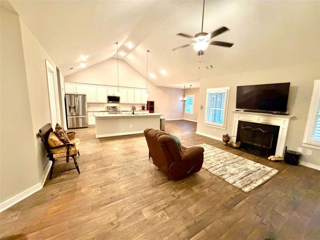 386 Westminster Trail Winder, GA 30680 - Photo 6 of 20 a living room with furniture a fireplace and a flat screen tv
