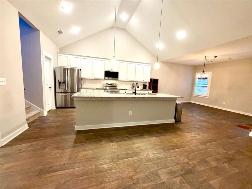 386 Westminster Trail Winder, GA 30680 - Photo 8 of 20 a kitchen with kitchen island a sink appliances and cabinets
