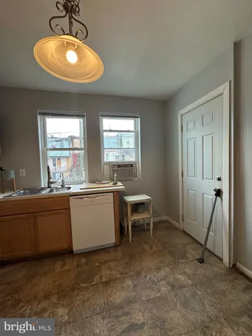 a view of a kitchen with furniture and a ceiling fan