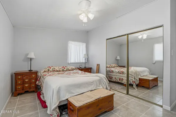 a bedroom with bed and a chandelier