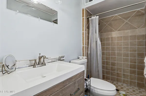 a bathroom with a sink mirror vanity and toilet