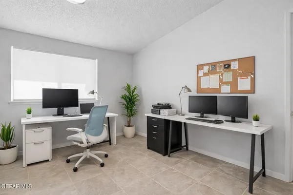 a view of a workspace with a computer on a desk and chair