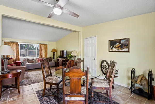 a dining room with furniture a rug and wooden floor