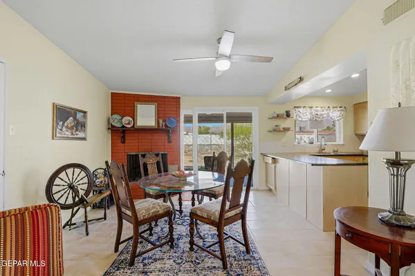 a view of a dining room with furniture and a chandelier