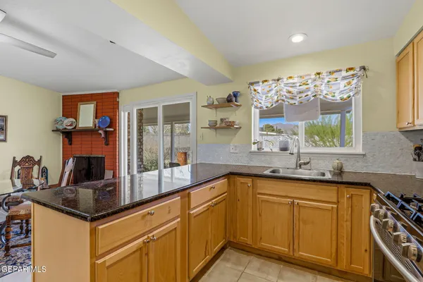 a kitchen with granite countertop a sink and cabinets