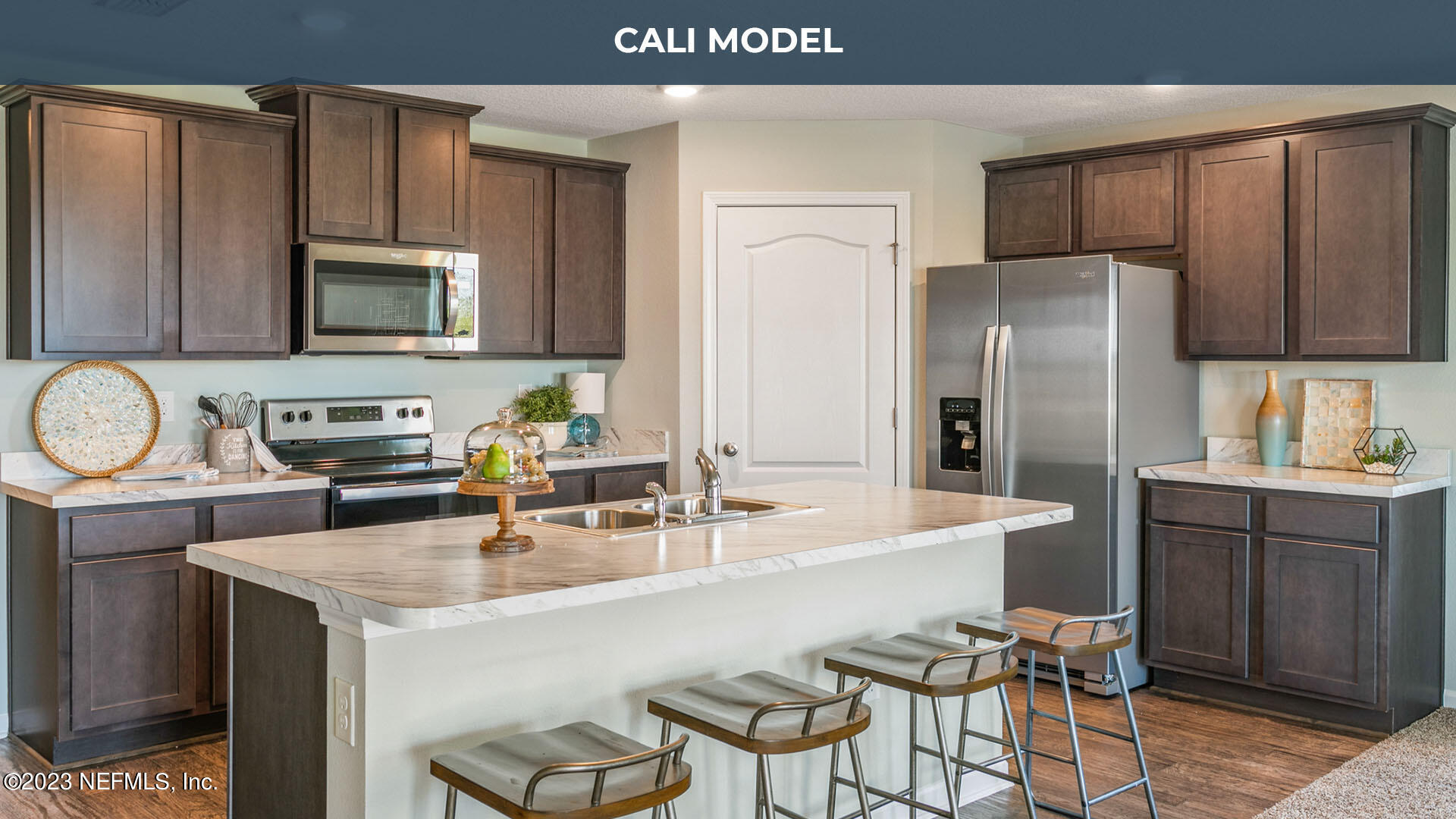 12583 Russian Olive Road Jacksonville, FL 32218 - Photo 11 of 32 a kitchen with stainless steel appliances a sink a microwave a refrigerator and chairs