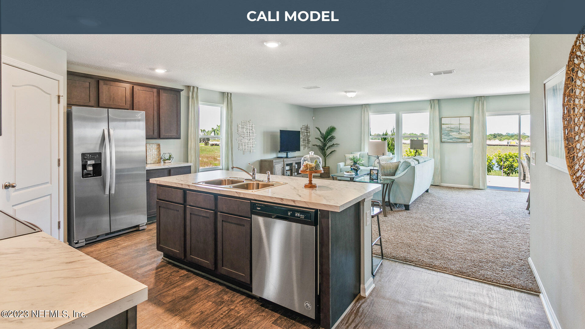 12583 Russian Olive Road Jacksonville, FL 32218 - Photo 10 of 32 a kitchen with kitchen island granite countertop a sink refrigerator and cabinets