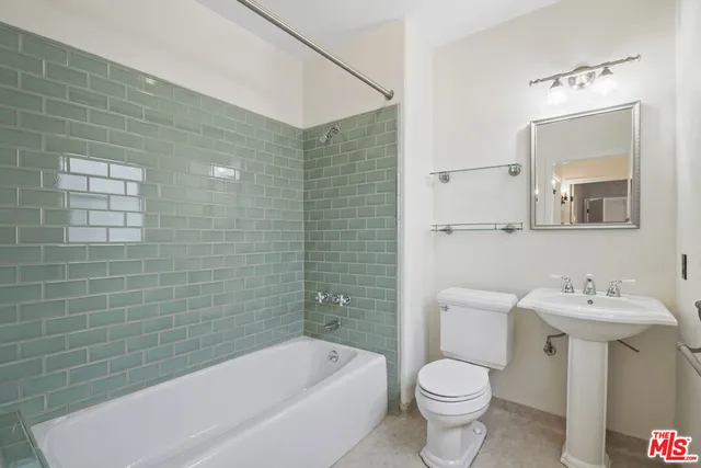 a bathroom with a sink mirror toilet and bathtub