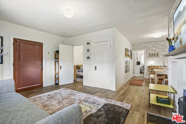 a spacious bedroom with a bed and a view of living room