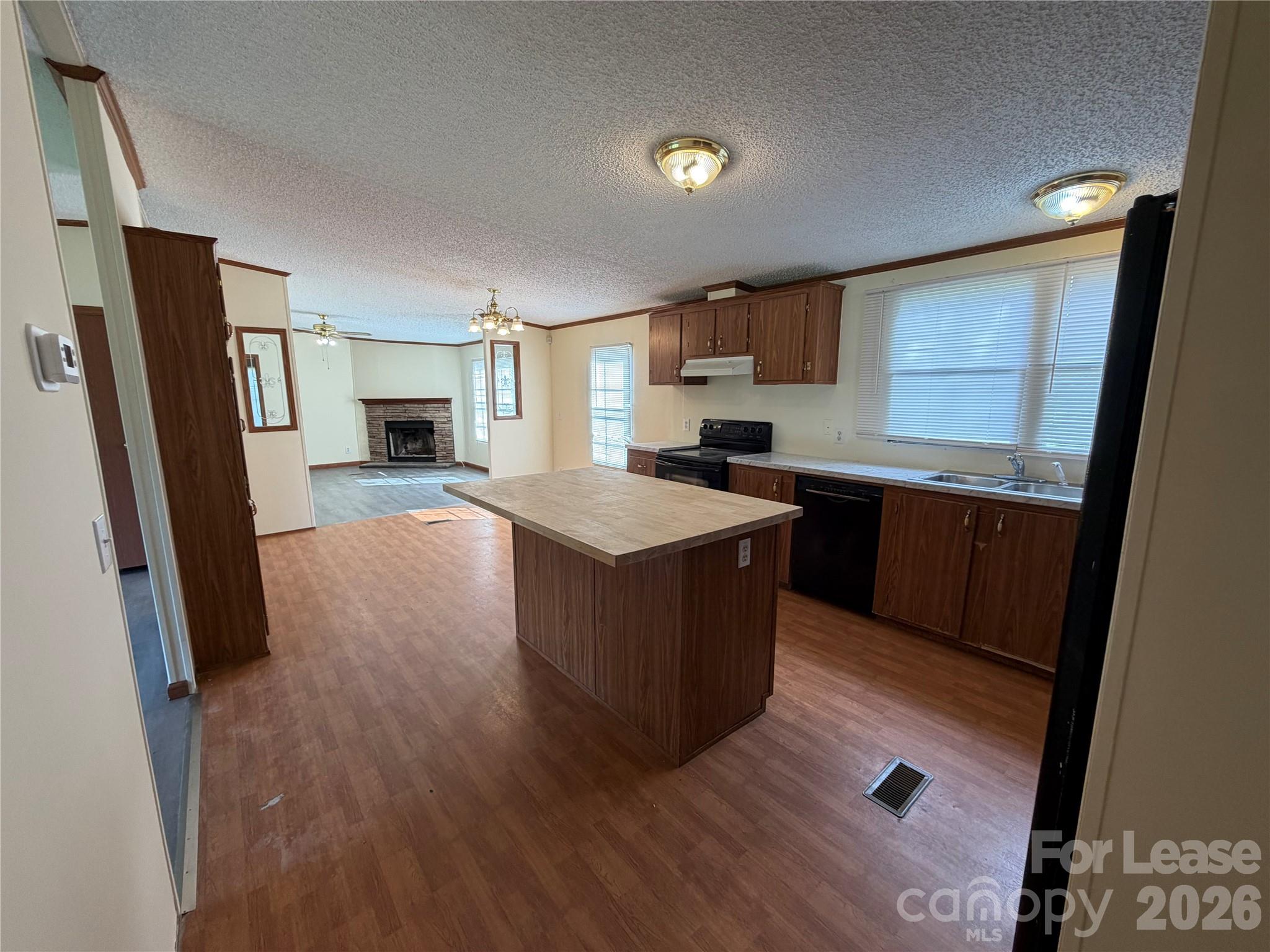 7141 Lingerfelt Road Vale, NC 28168 - Photo 11 of 25 a kitchen with stainless steel appliances granite countertop a refrigerator a sink dishwasher a stove and white countertops with wooden floor