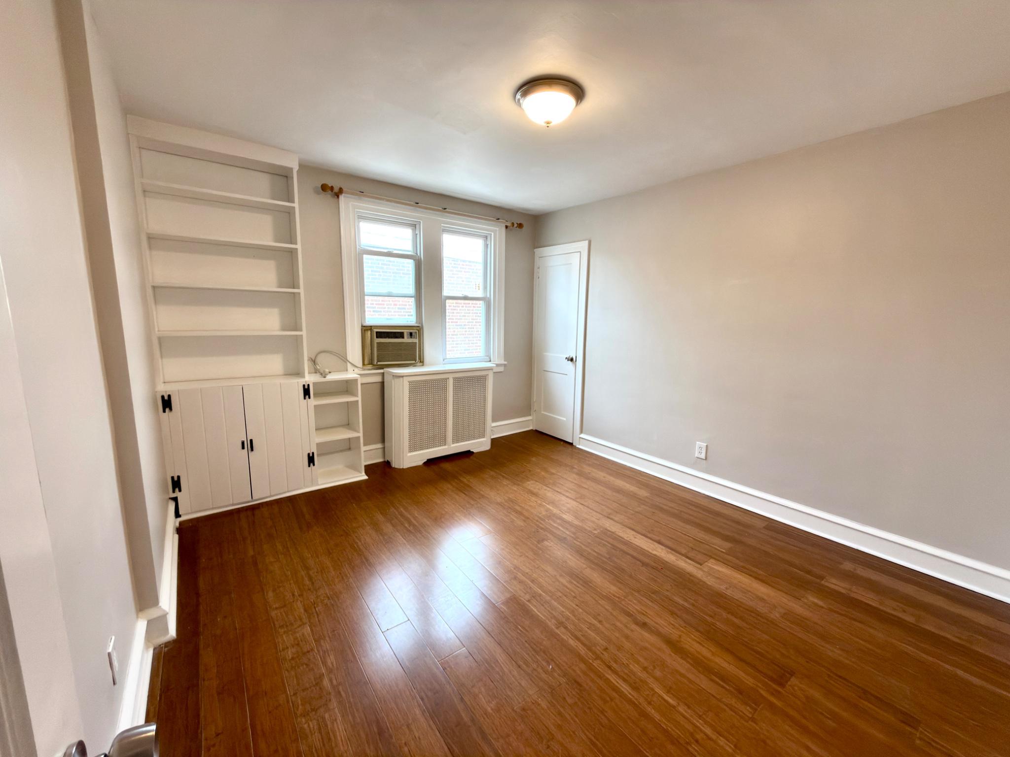 1723 Chelsea Road Elkins Park, PA 19027 - Photo 20 of 38 an empty room with wooden floor and windows