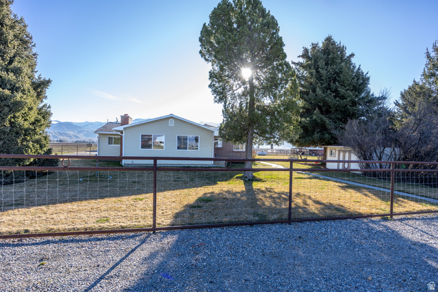 1981 South Main Street Lewiston, UT 84320 - Photo 40 of 47 Single story home featuring a fenced backyard, a chimney, and a mountain view