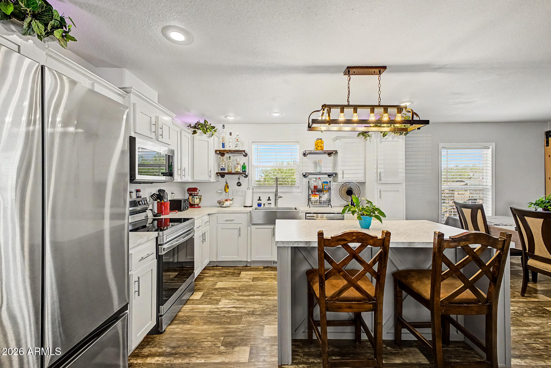 22417 West Dove Valley Road Wittmann, AZ 85361 - Photo 12 of 53 a kitchen with refrigerator and cabinets