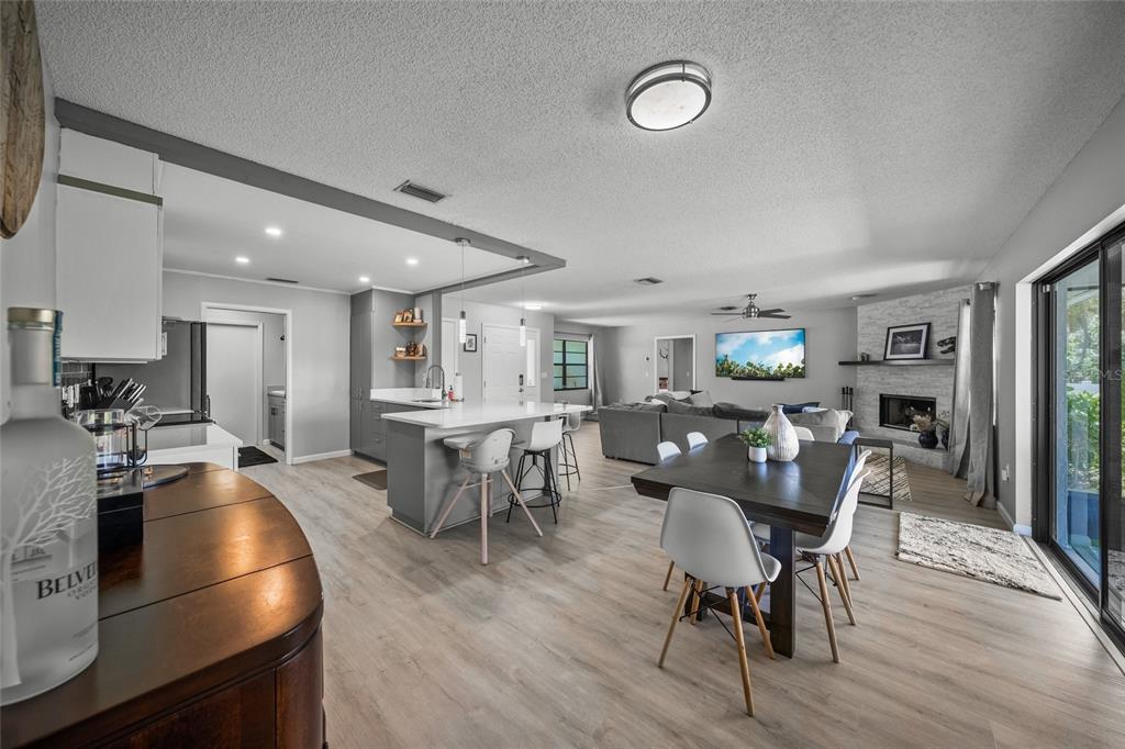 3020 Gypsy Street Sarasota, FL 34231 - Photo 11 of 34 a dining room with furniture and a wooden floor