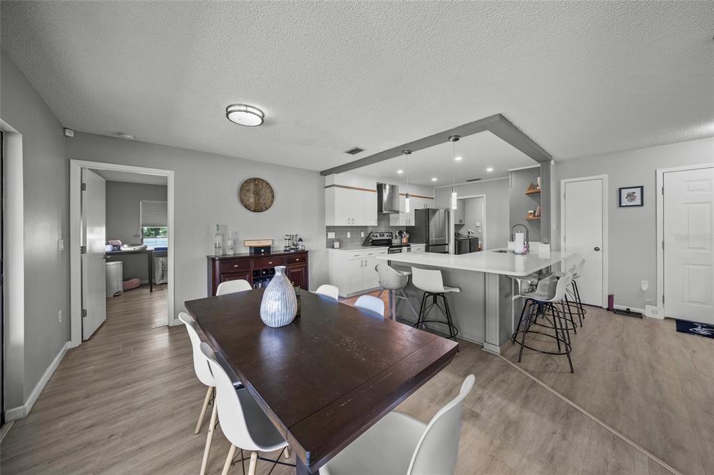 3020 Gypsy Street Sarasota, FL 34231 - Photo 12 of 34 a view of a dining room with furniture and wooden floor