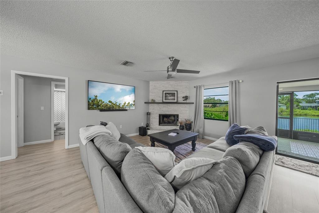 3020 Gypsy Street Sarasota, FL 34231 - Photo 13 of 34 a living room with furniture fireplace and a flat screen tv