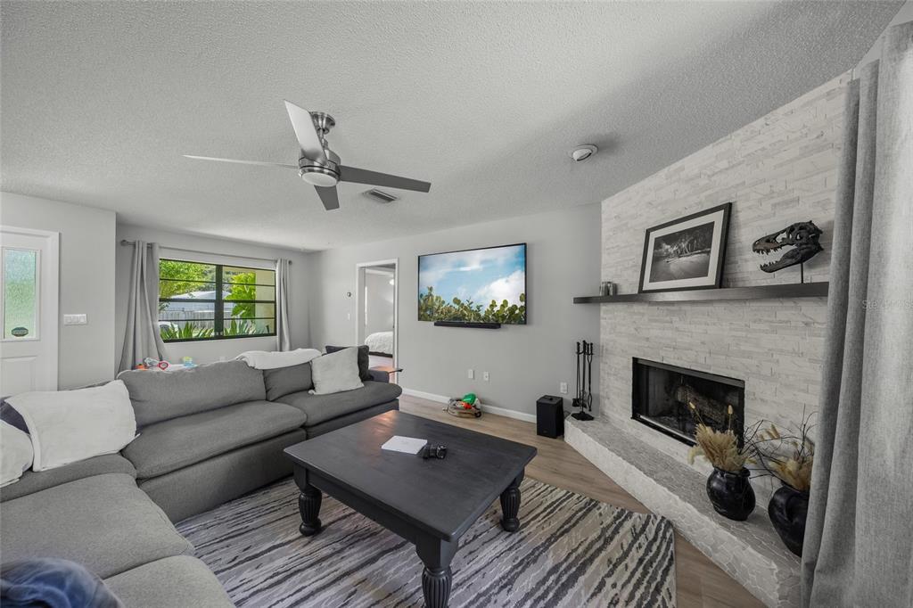 3020 Gypsy Street Sarasota, FL 34231 - Photo 15 of 34 a living room with furniture and a fireplace