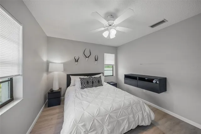 a bathroom with a toilet sink vanity and mirror