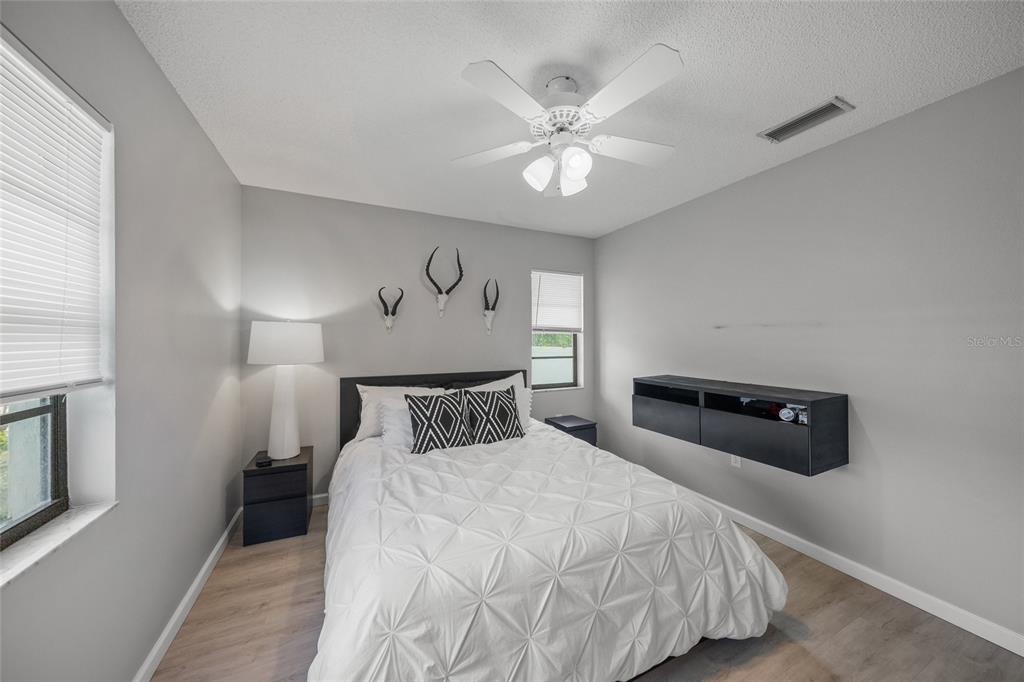 3020 Gypsy Street Sarasota, FL 34231 - Photo 17 of 34 a bedroom with a bed and a chandelier