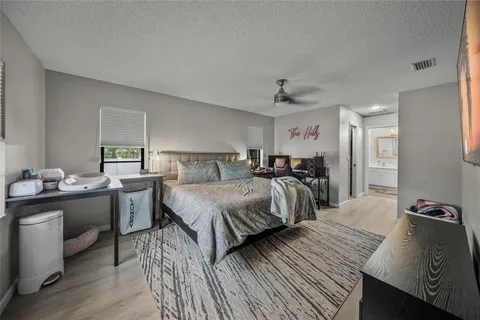 a bedroom with a bed and a tv