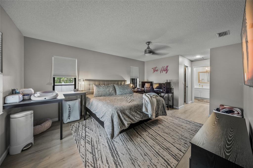 3020 Gypsy Street Sarasota, FL 34231 - Photo 19 of 34 a bedroom with a bed and wooden floor