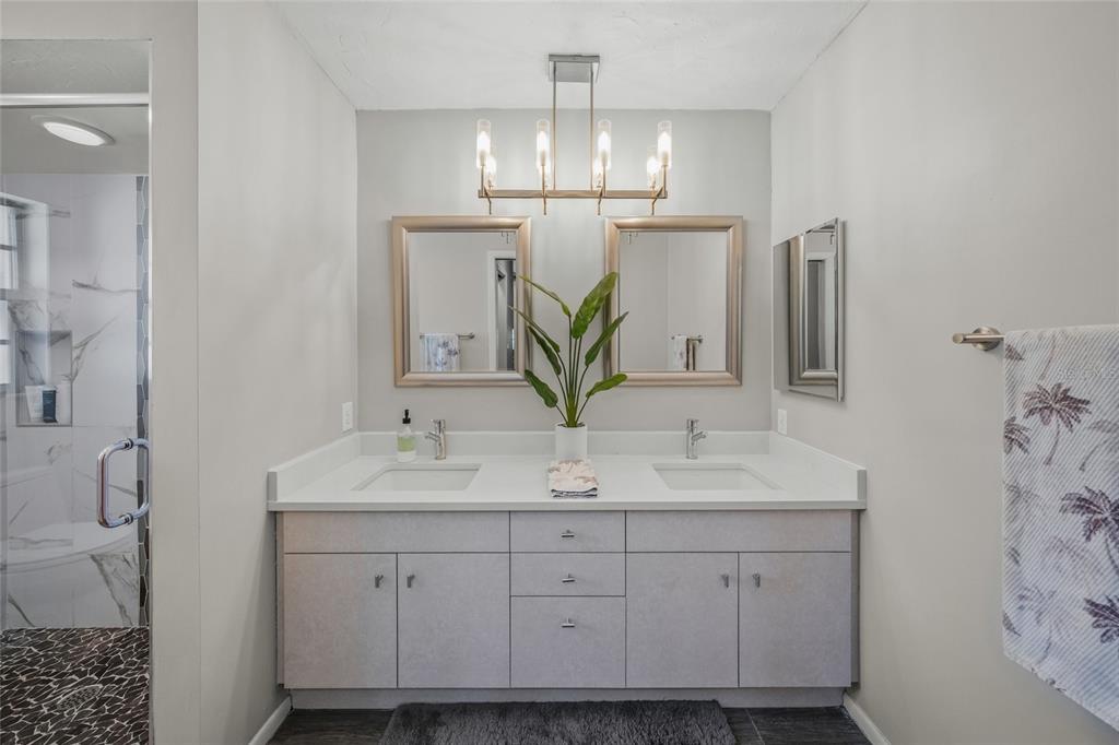 3020 Gypsy Street Sarasota, FL 34231 - Photo 23 of 34 a bathroom with a double vanity sink and a mirror