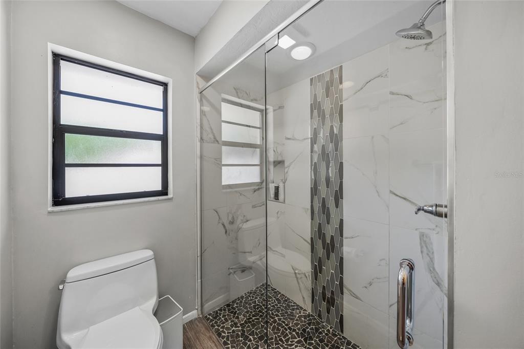 3020 Gypsy Street Sarasota, FL 34231 - Photo 24 of 34 a bathroom with a shower toilet and sink