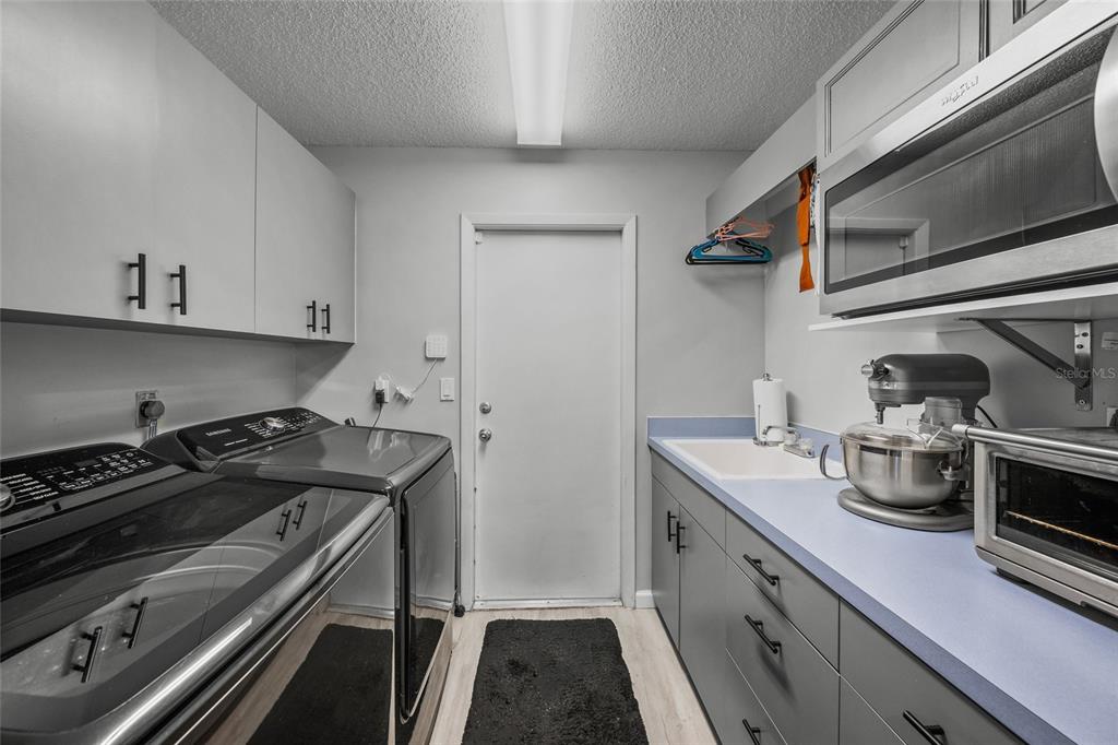 3020 Gypsy Street Sarasota, FL 34231 - Photo 28 of 34 a kitchen with a stove and a sink