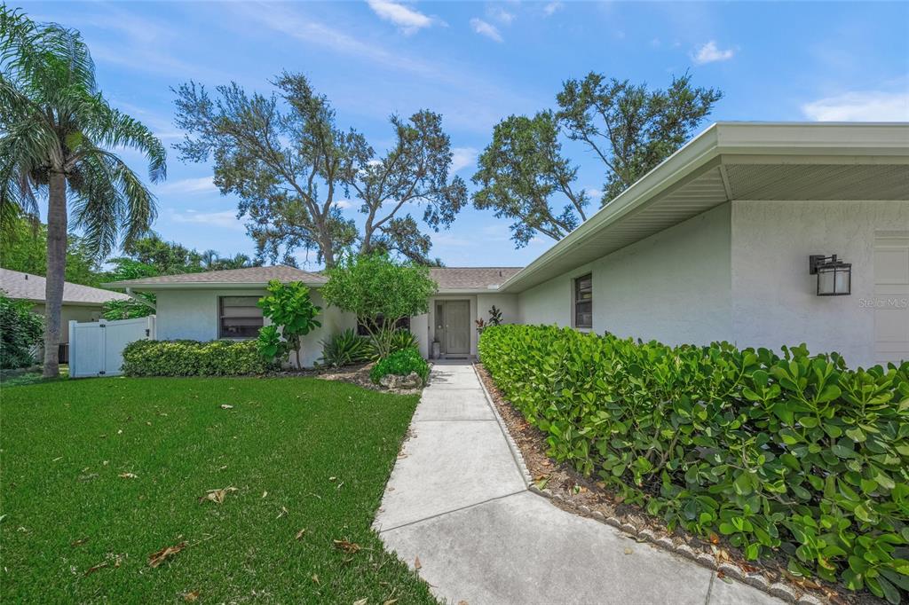 3020 Gypsy Street Sarasota, FL 34231 - Photo 3 of 34 a front view of a house with garden