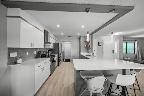 a kitchen with a stove and a refrigerator