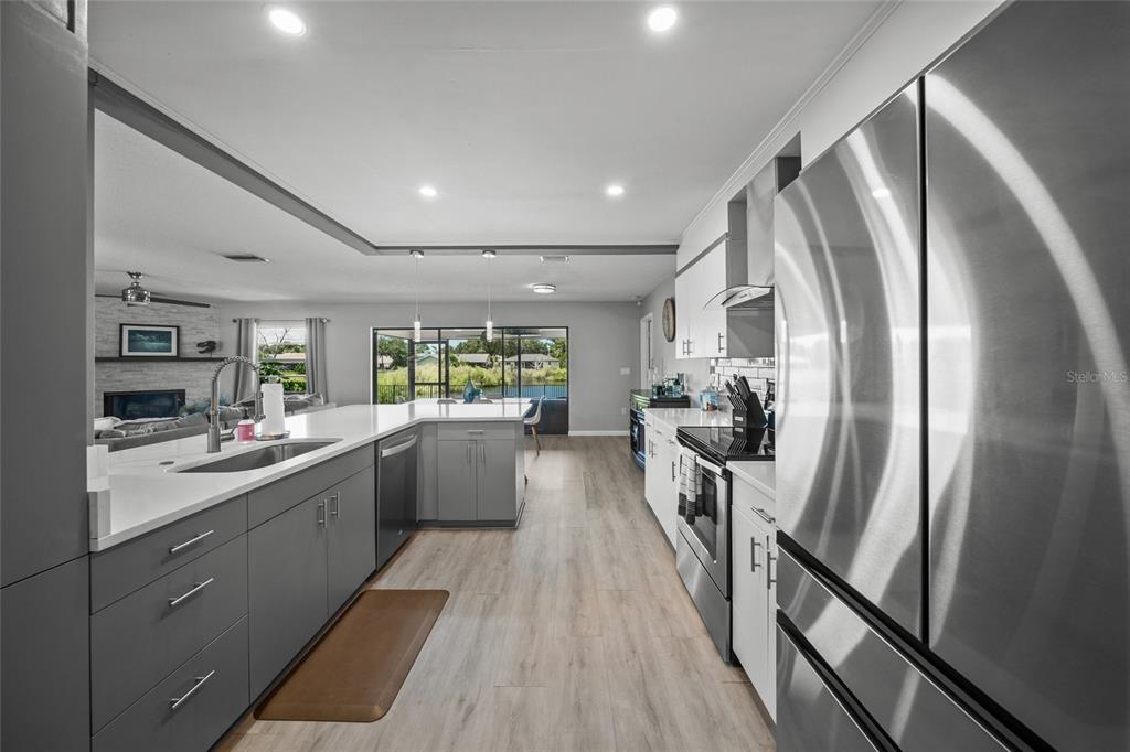 3020 Gypsy Street Sarasota, FL 34231 - Photo 8 of 34 a kitchen with sink a refrigerator and wooden floor