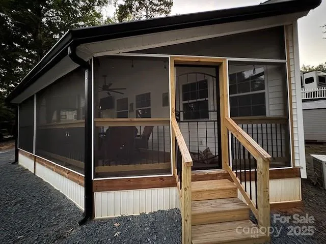 a view of a small house with a yard and outdoor seating