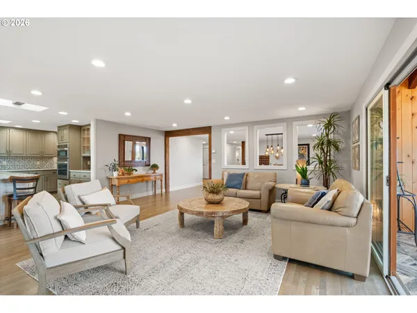 a kitchen with stainless steel appliances kitchen island granite countertop a stove and white cabinets