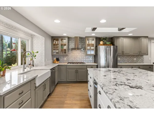 a bathroom with a granite countertop toilet sink mirror and vanity
