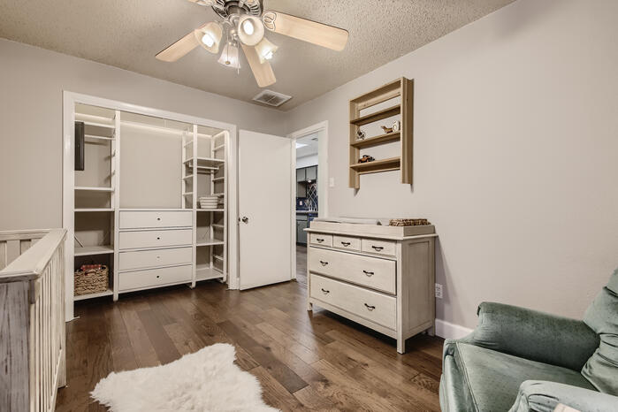 5107 Leralynn Street, Unit 304 Austin, TX 78751 - Photo 20 of 28 Sitting room with ceiling fan, dark wood-style floors, and a textured ceiling
