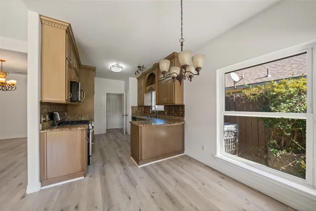 a kitchen with a refrigerator and a stove top oven