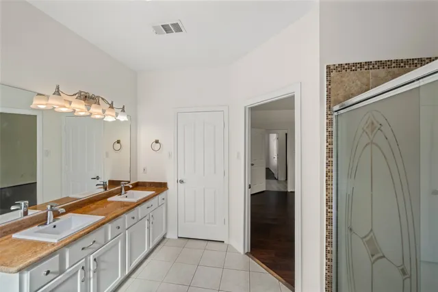 a bathroom with a double vanity sink and a mirror