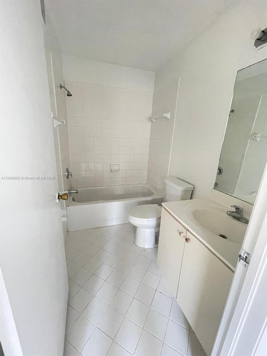 2921 Southeast 13th Road, Unit 20539 Homestead, FL 33035 - Photo 13 of 17 a bathroom with a sink a toilet and shower