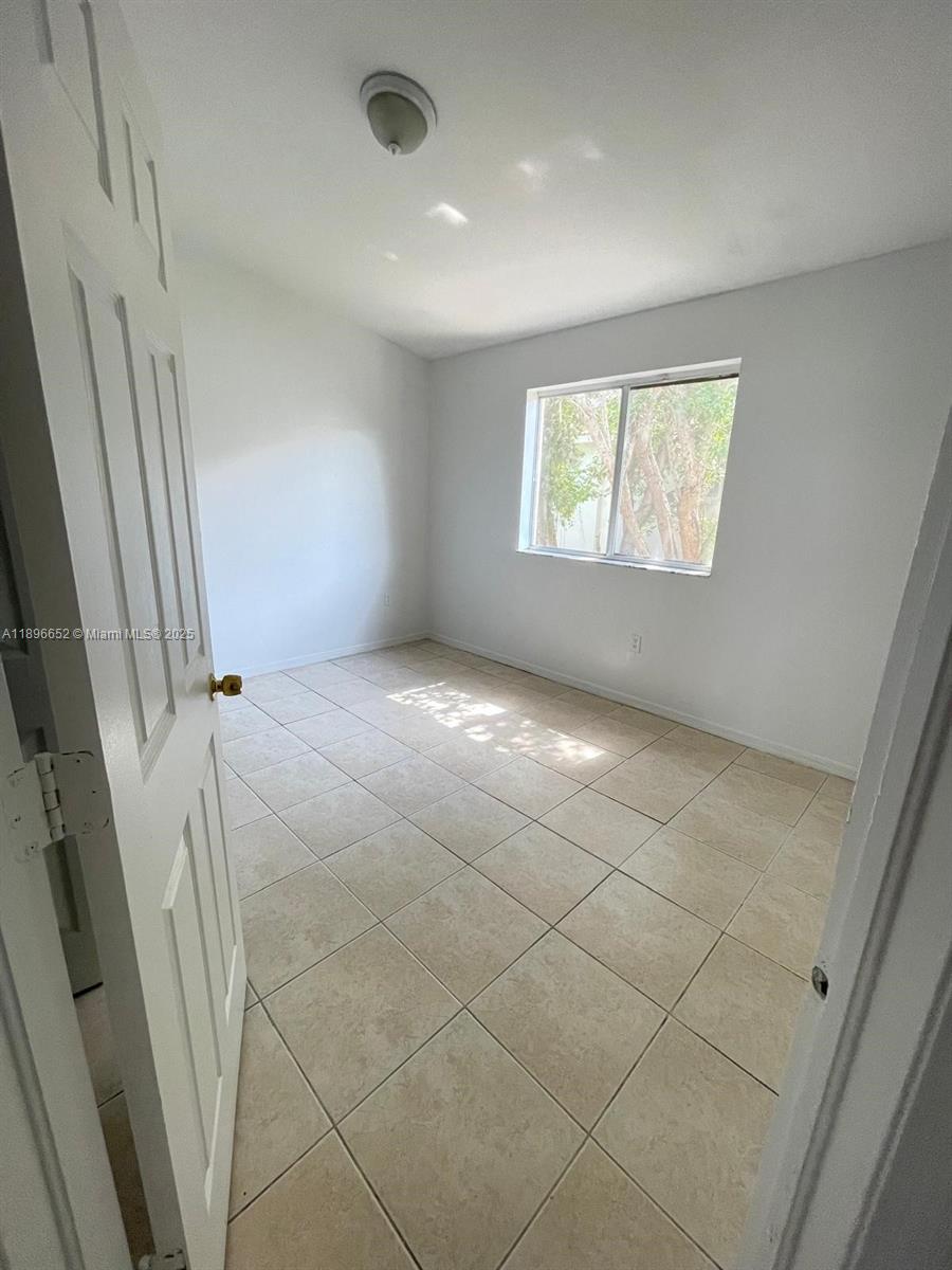 2921 Southeast 13th Road, Unit 20539 Homestead, FL 33035 - Photo 8 of 17 a view of an empty room and a window