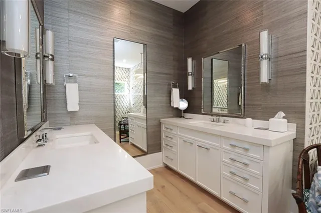 a bathroom with a double vanity sink and mirror