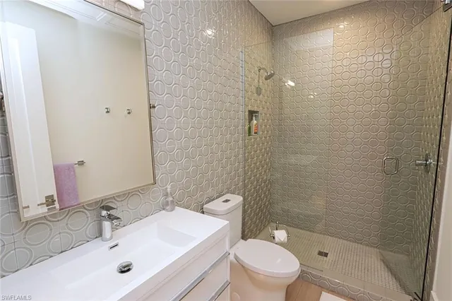 a bathroom with a sink shower and a toilet