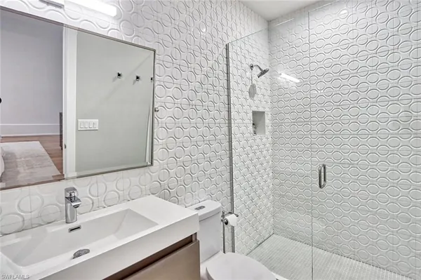 a bathroom with a sink toilet and shower